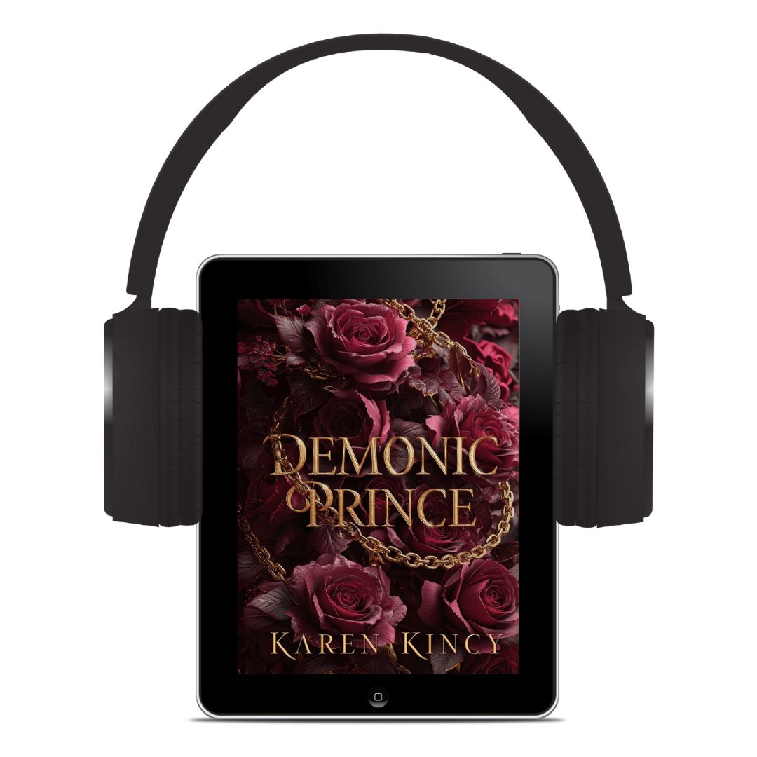 Tablet with 'Demonic Prince' book cover displayed, surrounded by headphones on a white background