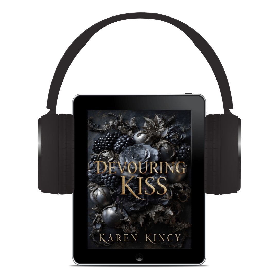 Tablet with 'Devouring Kiss' book cover displayed, flanked by headphones on a white background