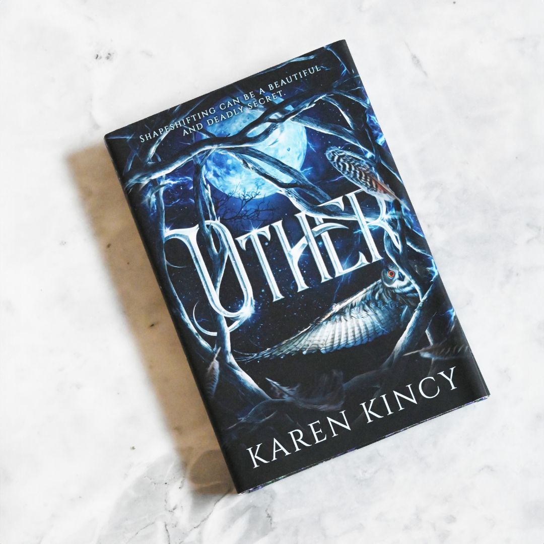 Book titled 'Other' by Karen Kincy on a textured white surface