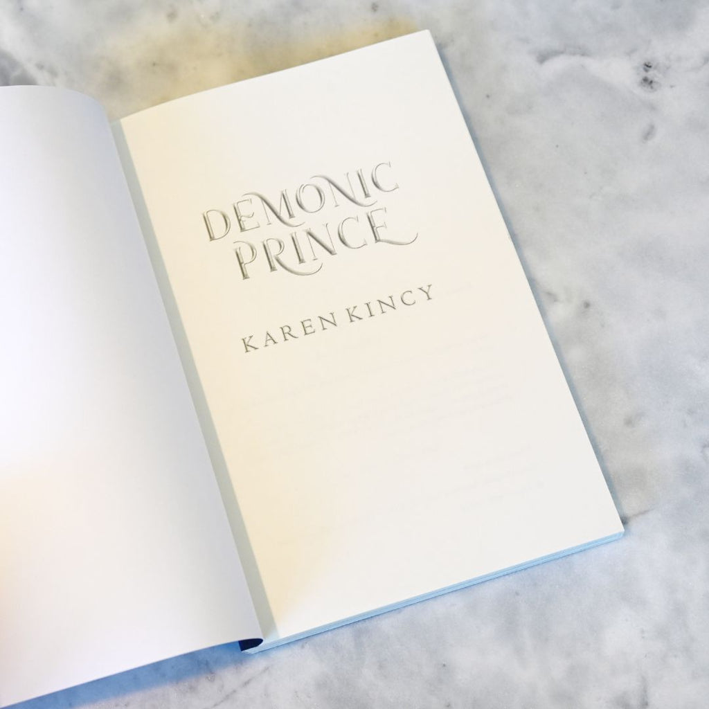 Book titled 'Demonic Prince' by Karen Kincy on a marble surface