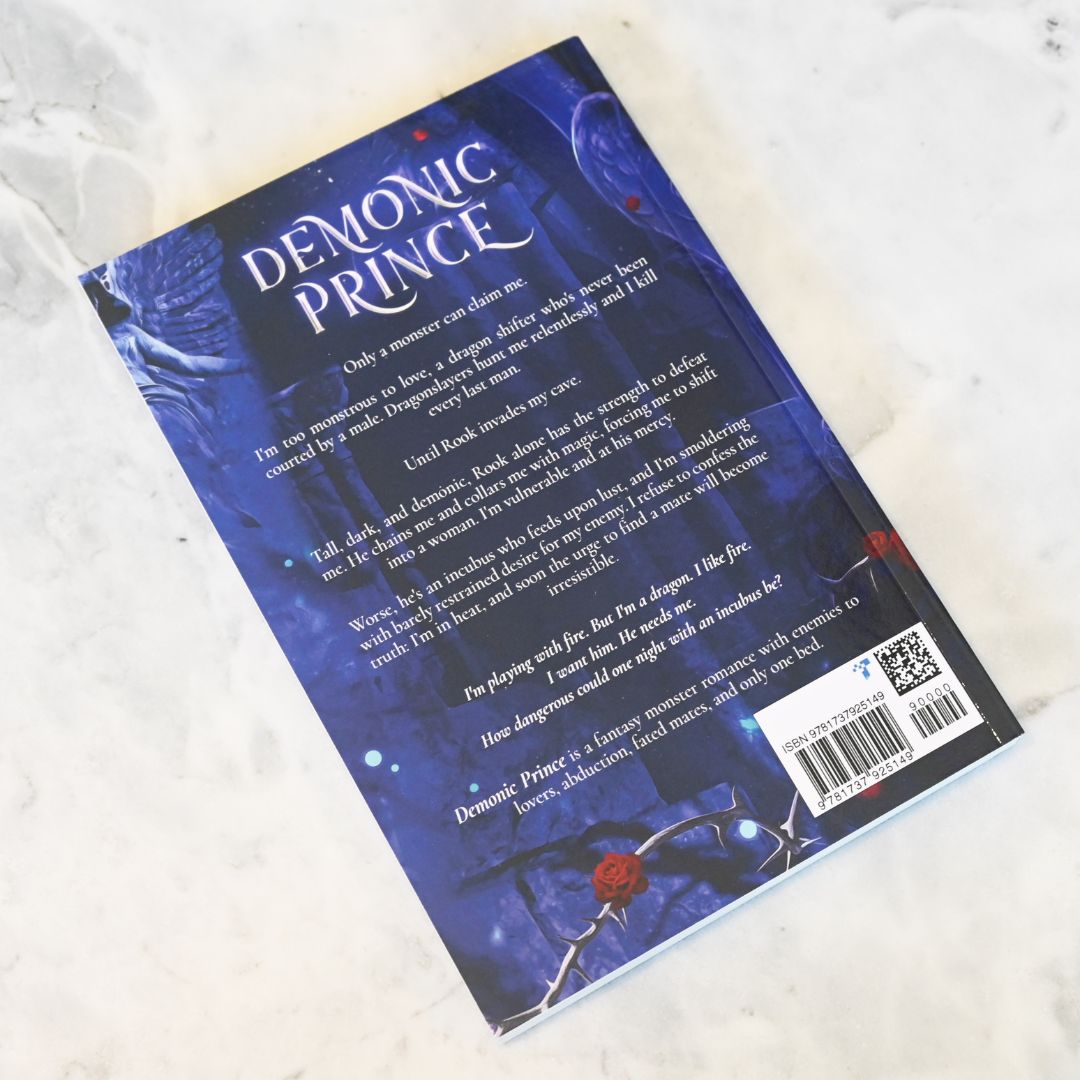 Book titled 'Demonic Prince' with a blue cover and text on a white textured background