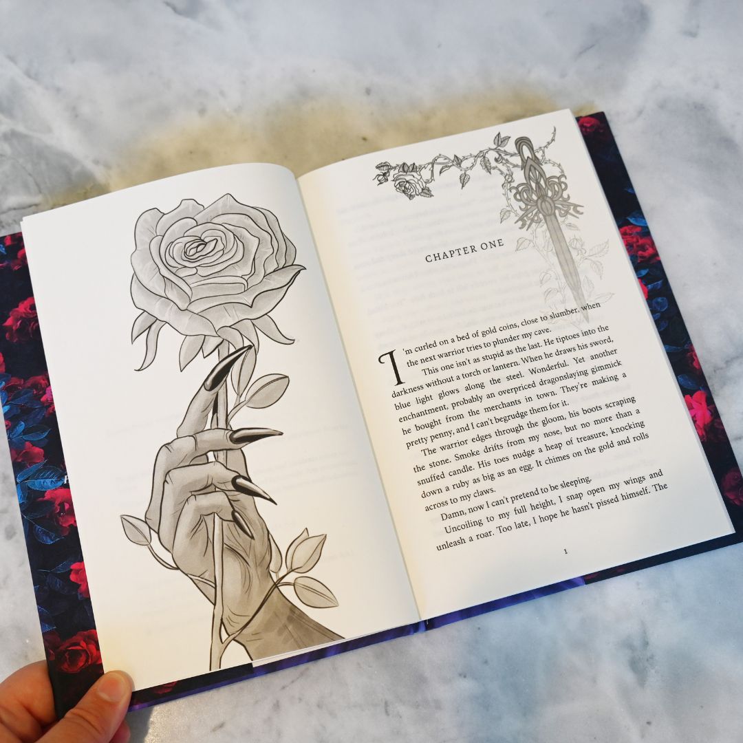 Open book with a rose and hand illustration on a textured surface