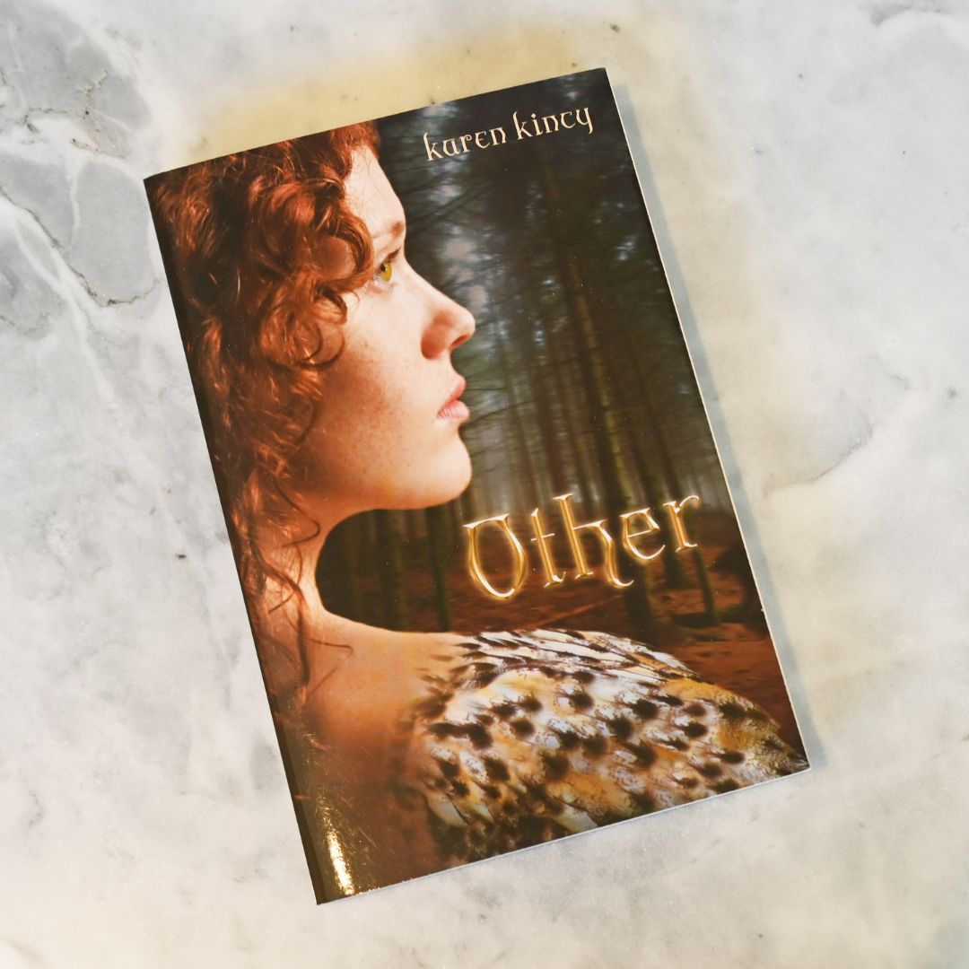 Book cover of 'Other' by Karen Kincy with a woman's profile and forest background on a textured surface.