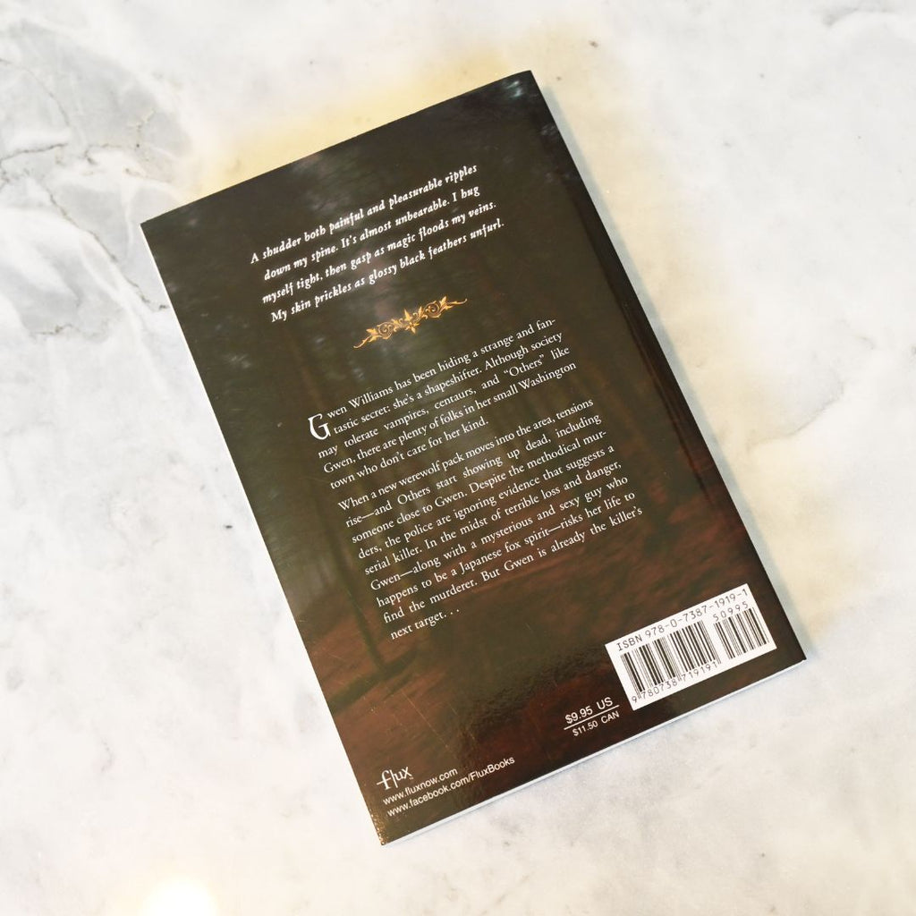 Back cover of a book with text and a barcode on a textured surface
