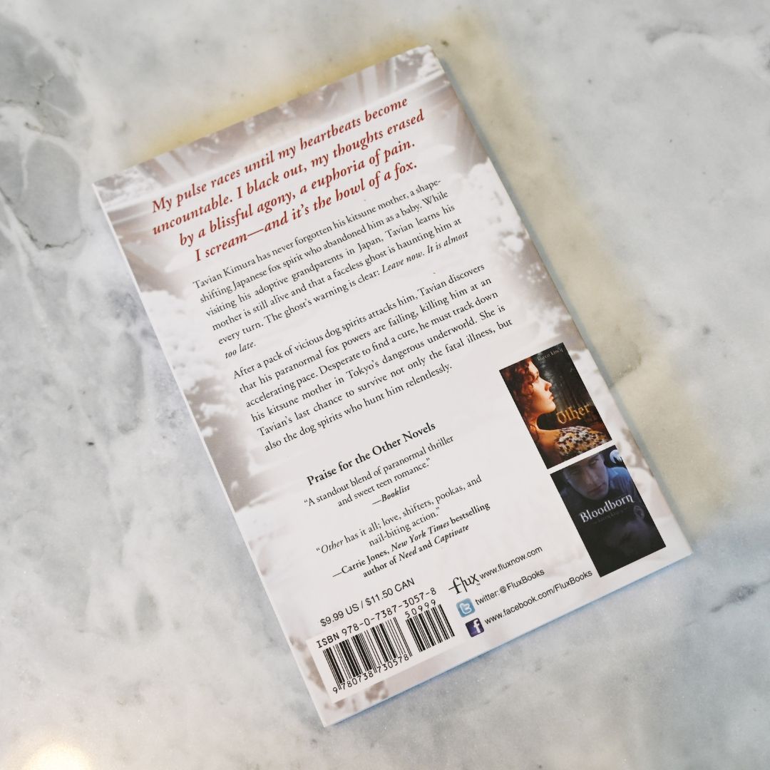 Back cover of a book with text and images on a textured surface