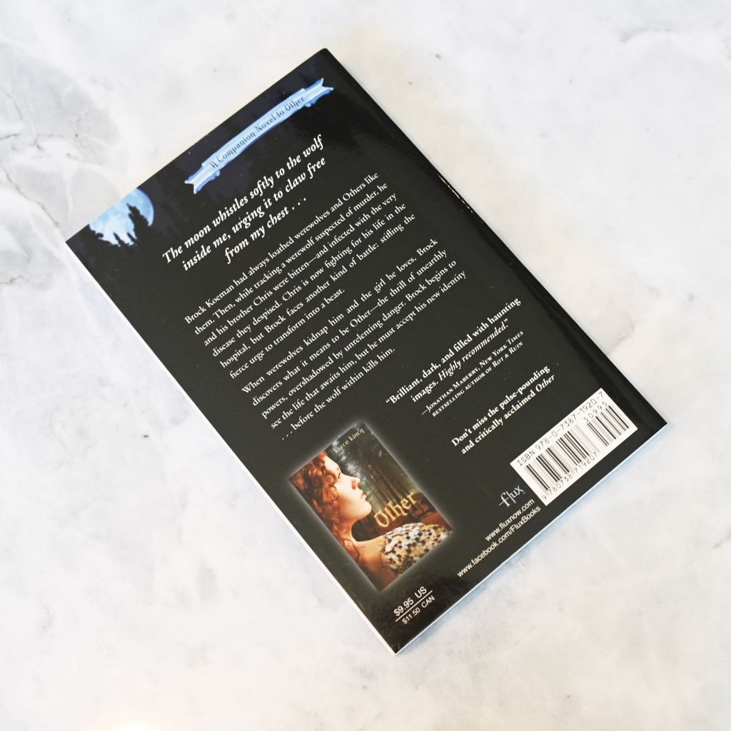 Back cover of a book with text and a barcode on a textured white surface